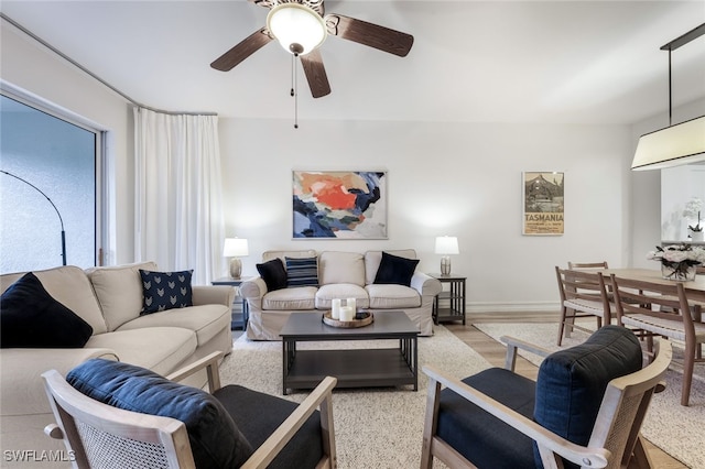 living room with ceiling fan and light wood-style flooring