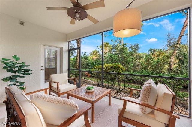 sunroom with ceiling fan and visible vents