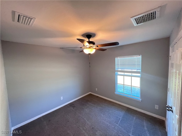 carpeted spare room featuring ceiling fan