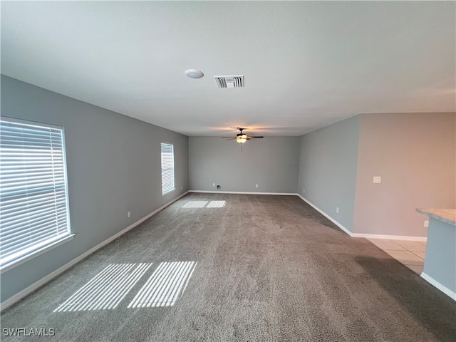 spare room featuring ceiling fan and light colored carpet