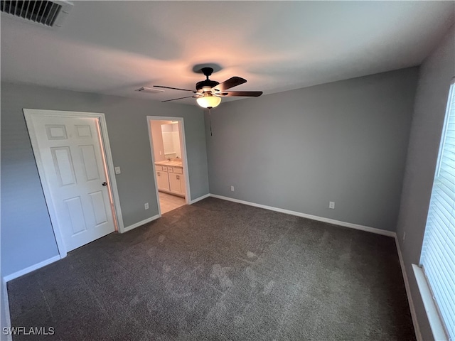 unfurnished bedroom featuring carpet floors, ensuite bath, and ceiling fan