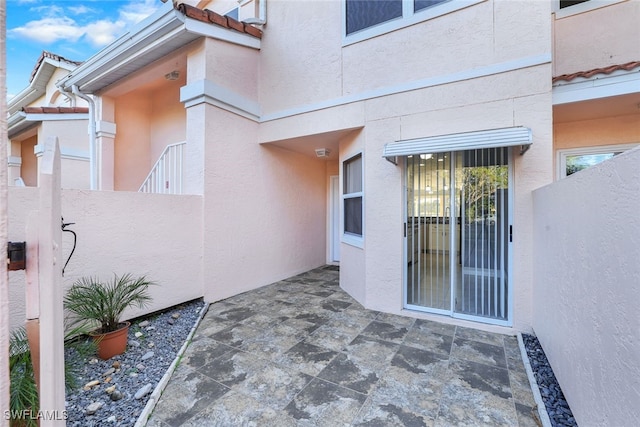 property entrance featuring a patio area