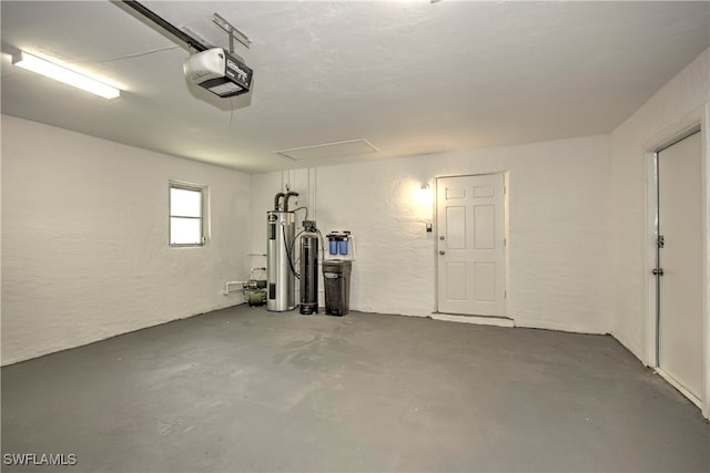 garage featuring a garage door opener and water heater