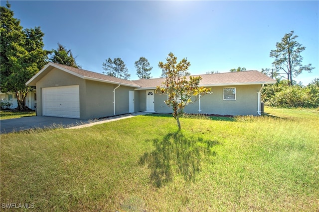 single story home with a garage and a front lawn