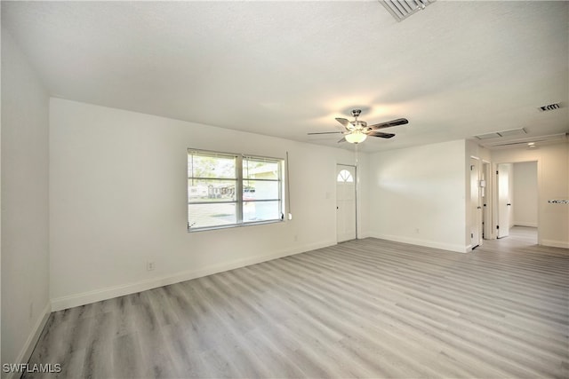 unfurnished room with ceiling fan, a textured ceiling, and light hardwood / wood-style flooring