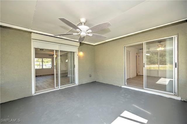 interior space with ceiling fan