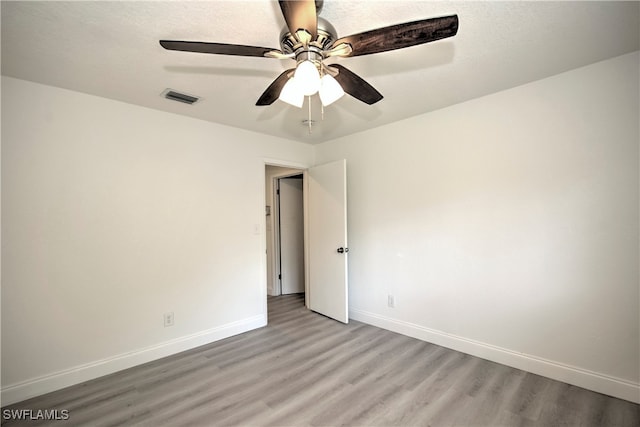 spare room featuring ceiling fan and light hardwood / wood-style floors