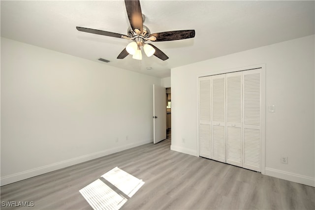 unfurnished bedroom featuring a closet, ceiling fan, and light hardwood / wood-style flooring