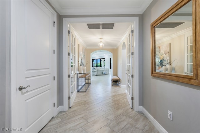 hall featuring french doors and ornamental molding