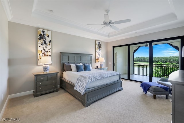 bedroom featuring access to exterior, a tray ceiling, ceiling fan, and light colored carpet