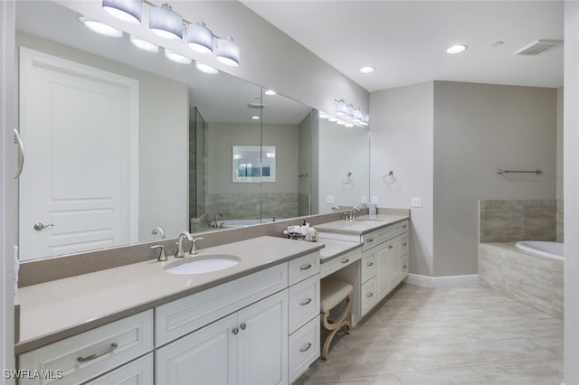 bathroom with tile patterned floors, vanity, and independent shower and bath