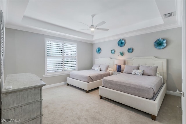 carpeted bedroom featuring ceiling fan, a raised ceiling, and ornamental molding