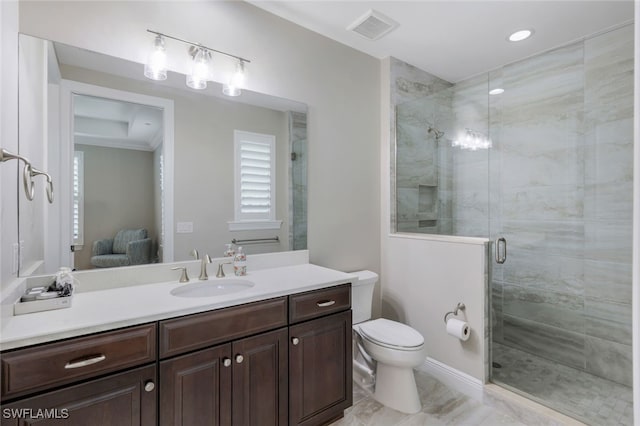 bathroom featuring vanity, toilet, and a shower with door