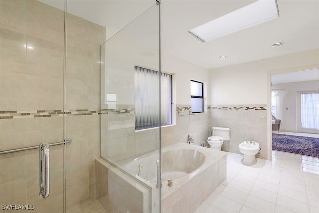 bathroom featuring tile patterned floors, a bidet, shower with separate bathtub, toilet, and tile walls