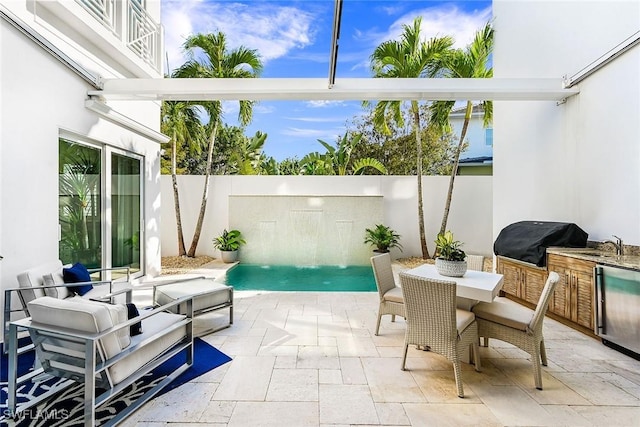 view of patio / terrace featuring a balcony, grilling area, a fenced in pool, and sink