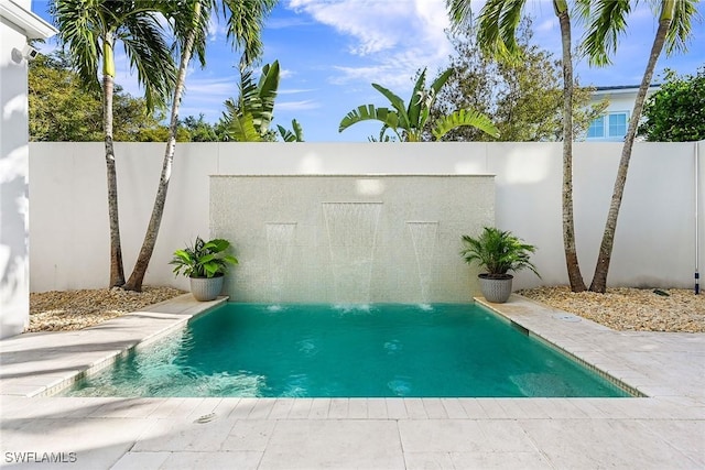 view of pool with pool water feature