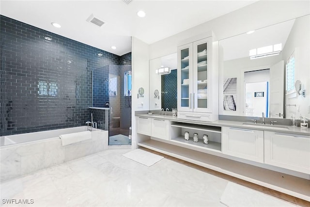 bathroom featuring separate shower and tub and vanity