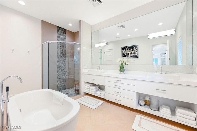 bathroom featuring tile patterned flooring, vanity, and plus walk in shower