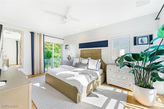 bedroom featuring access to outside, light hardwood / wood-style flooring, and ceiling fan