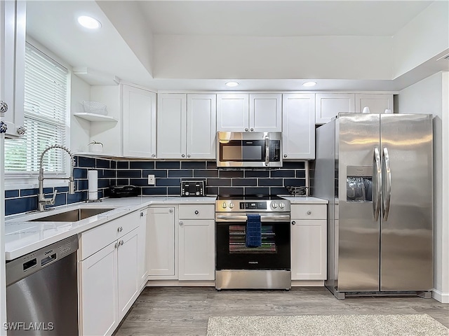 kitchen featuring white cabinetry, sink, and appliances with stainless steel finishes