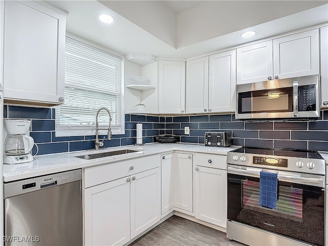 kitchen featuring white cabinetry, sink, and appliances with stainless steel finishes