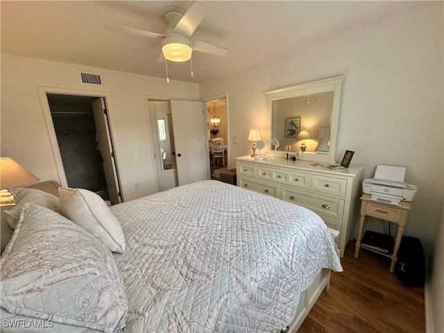 bedroom with a closet, dark hardwood / wood-style floors, and ceiling fan