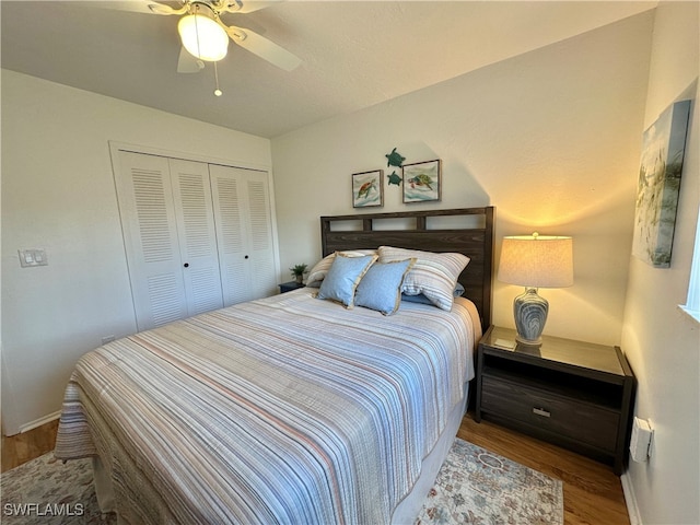 bedroom featuring ceiling fan, a closet, and hardwood / wood-style floors