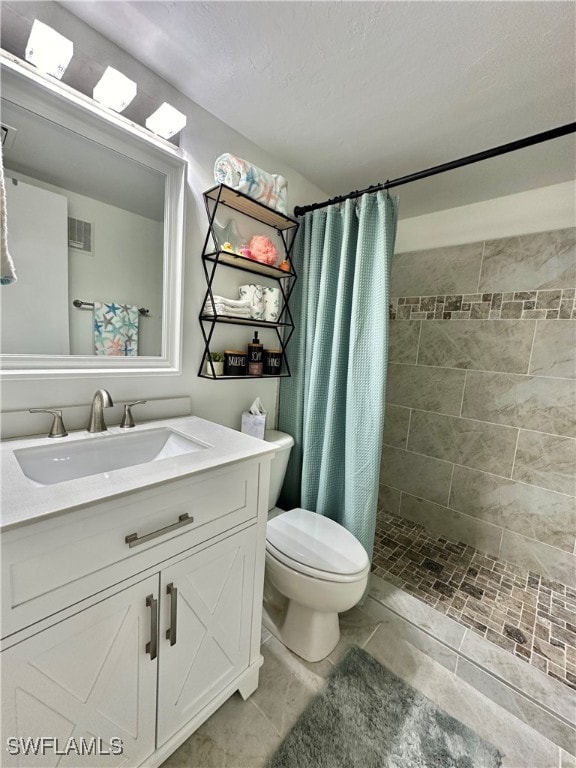 bathroom featuring curtained shower, vanity, and toilet