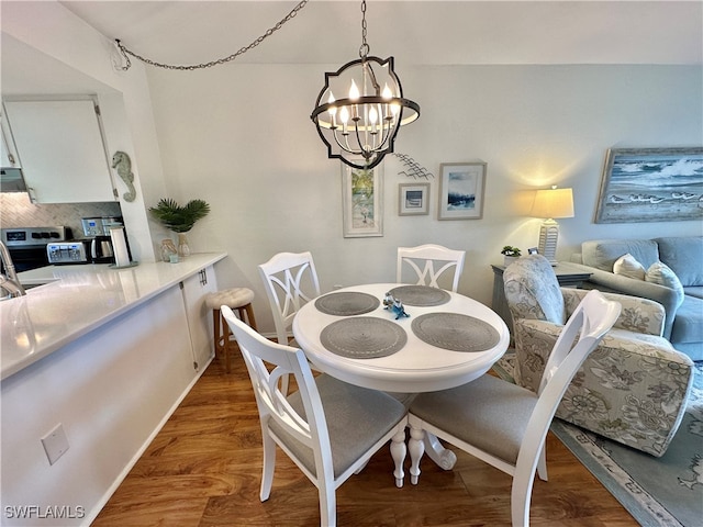 dining room featuring dark hardwood / wood-style flooring and a chandelier