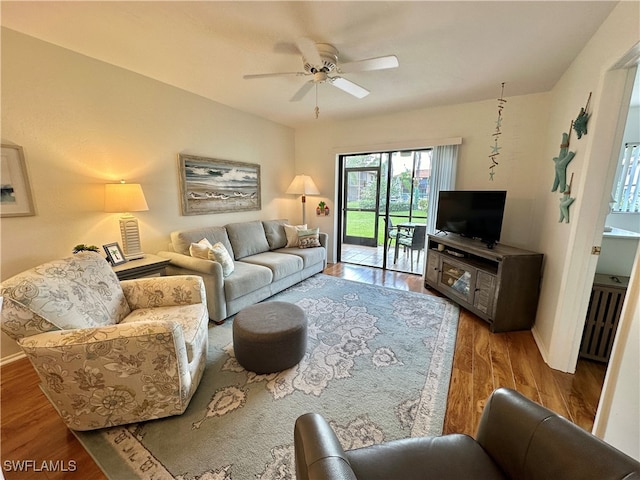 living room featuring hardwood / wood-style floors and ceiling fan