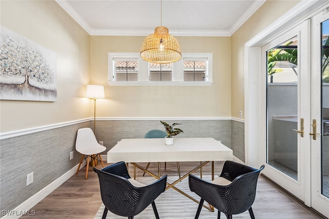 dining room with breakfast area, wood-type flooring, ornamental molding, and tile walls