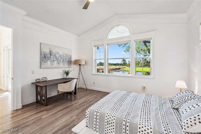 bedroom featuring vaulted ceiling, ceiling fan, crown molding, hardwood / wood-style flooring, and a water view