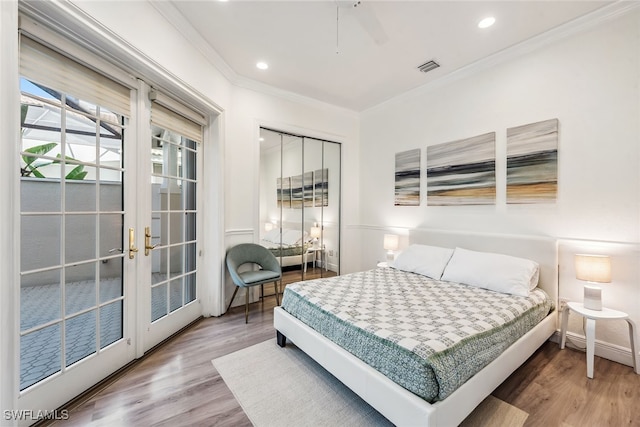 bedroom featuring ceiling fan, crown molding, french doors, and hardwood / wood-style flooring