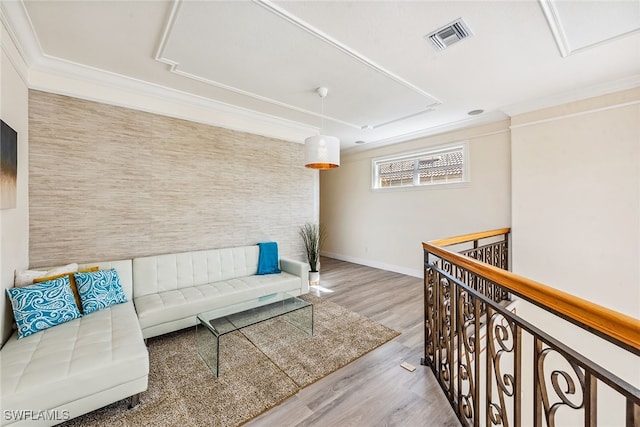 living room featuring light wood-type flooring and ornamental molding