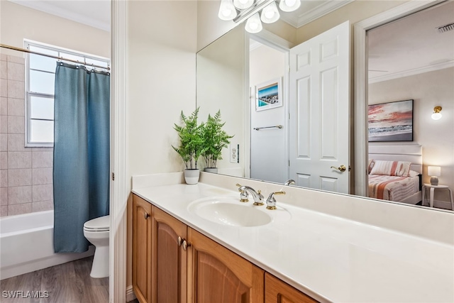 full bathroom with vanity, toilet, ornamental molding, wood-type flooring, and shower / tub combo