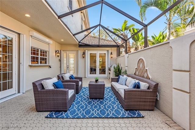 view of patio with a lanai, outdoor lounge area, and french doors