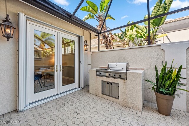 view of patio featuring area for grilling, french doors, and a balcony