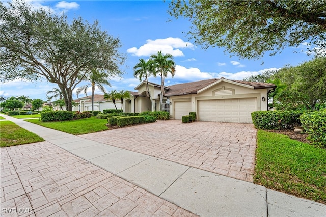 single story home with a front yard and a garage