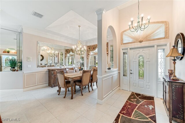 foyer entrance with crown molding and light tile patterned flooring