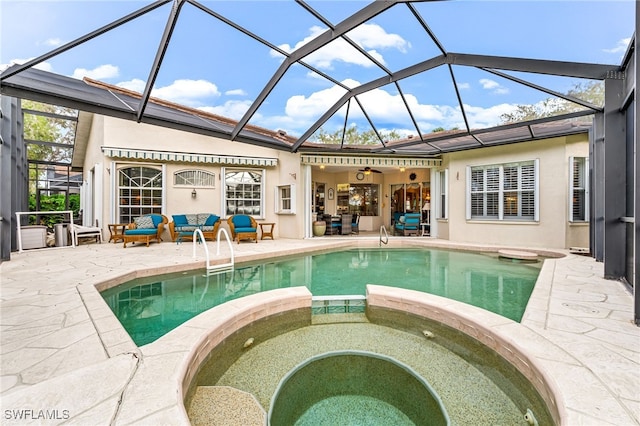 view of pool featuring an in ground hot tub, a patio, and a lanai