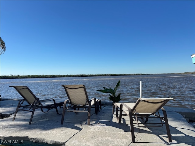 view of patio with a water view