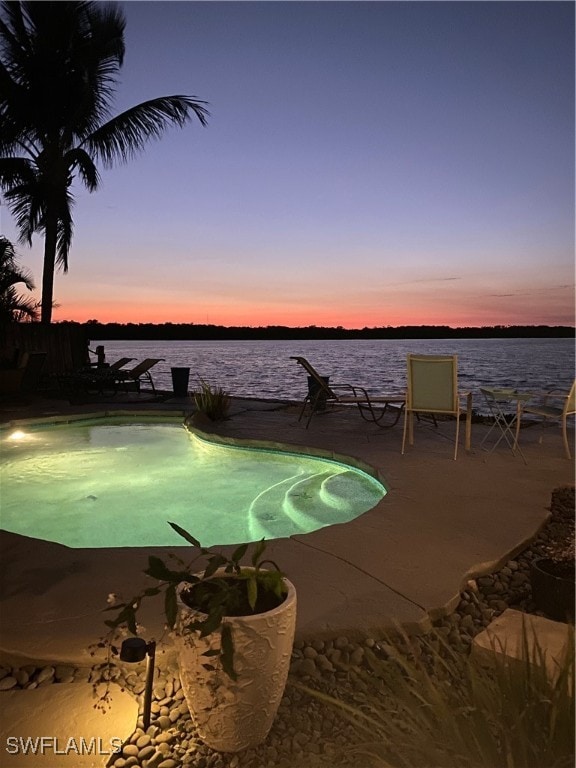 pool at dusk with a water view