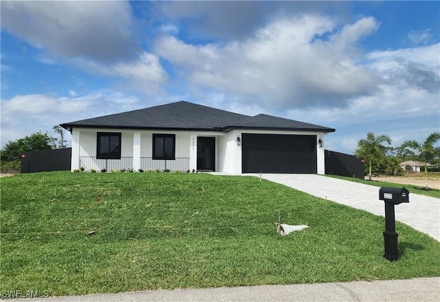 view of front of home with a front yard and a garage