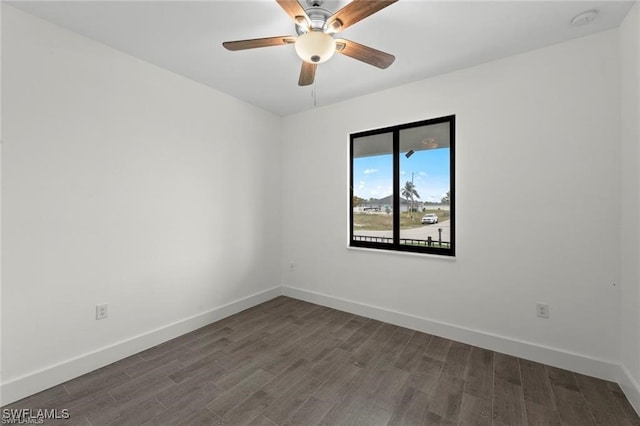 empty room featuring dark hardwood / wood-style flooring and ceiling fan