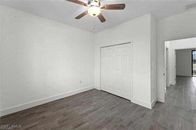 unfurnished bedroom featuring dark hardwood / wood-style flooring, a closet, and ceiling fan