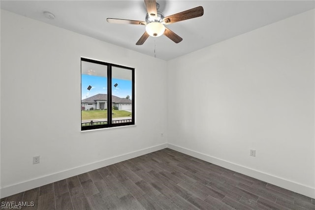 empty room featuring ceiling fan and dark wood-type flooring