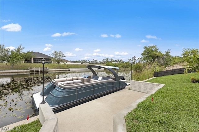 dock area with a lawn and a water view