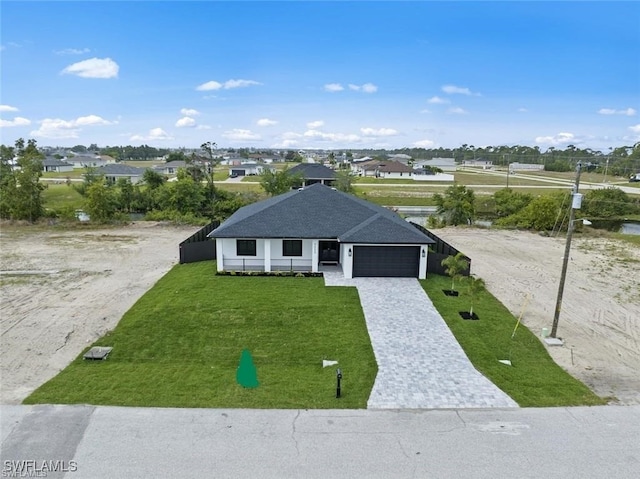 view of front facade featuring a front yard and a garage