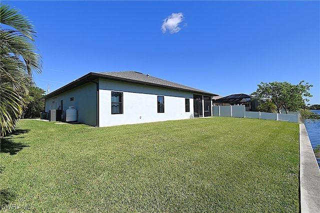 back of house with a lawn