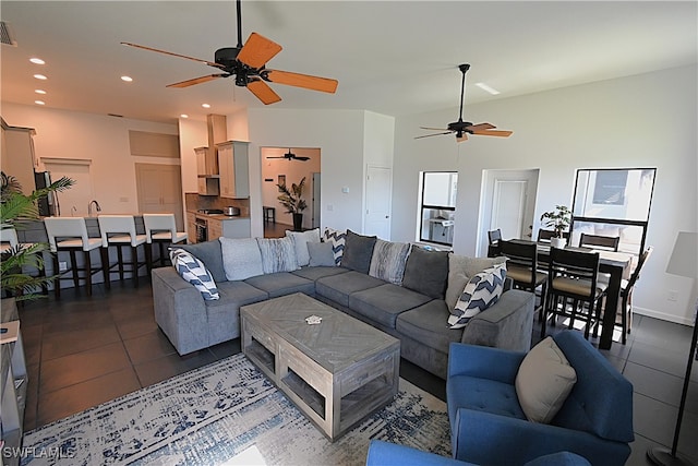 tiled living room with a towering ceiling